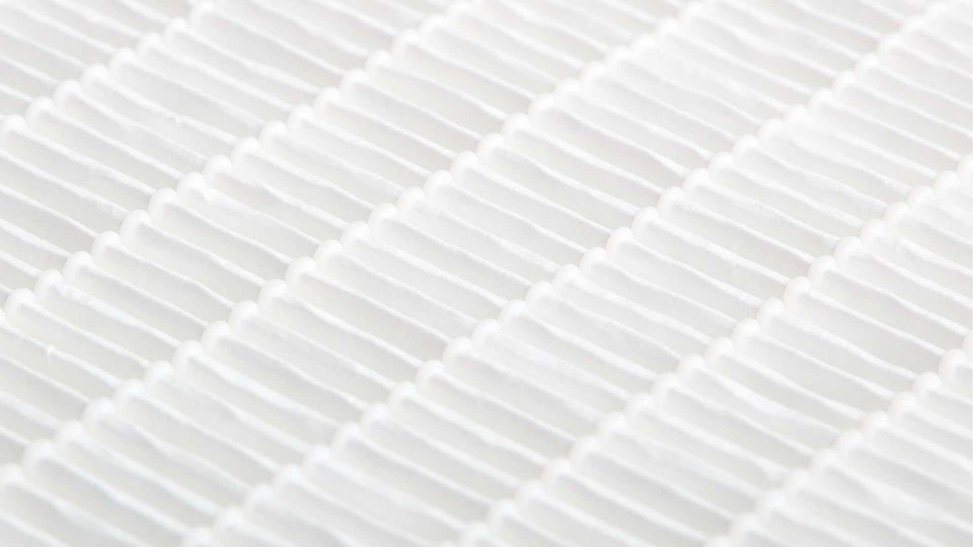 A close up of a white fabric with a striped pattern.