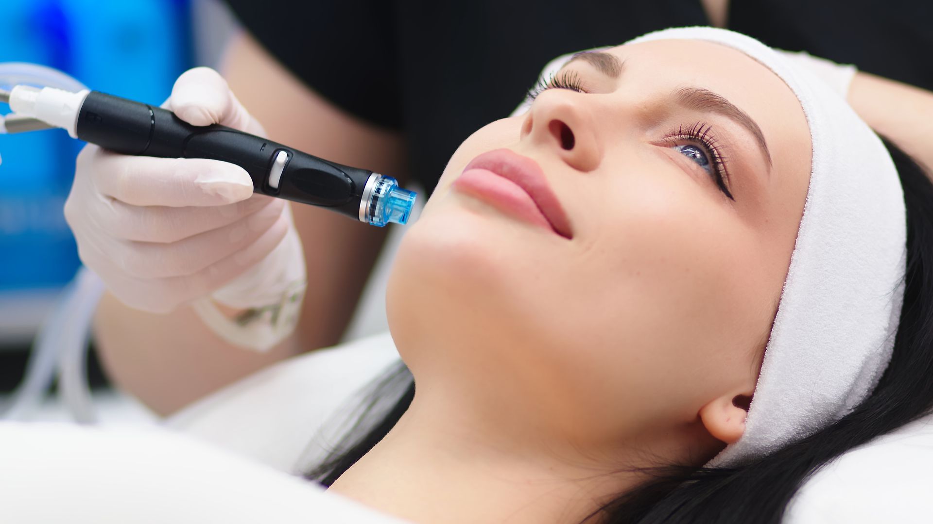 A woman is getting a facial treatment