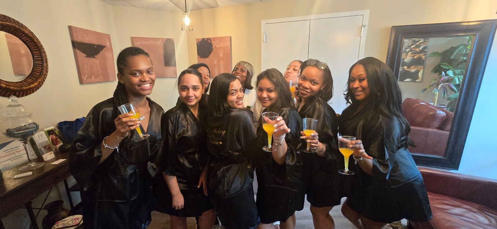 A group of women are standing next to each other in a spa holding champagne glasses.