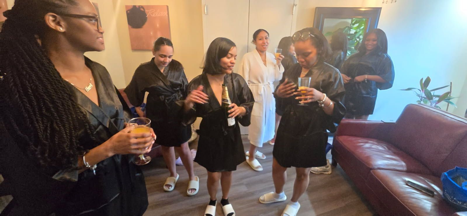 A group of women are standing in a spa holding drinks.