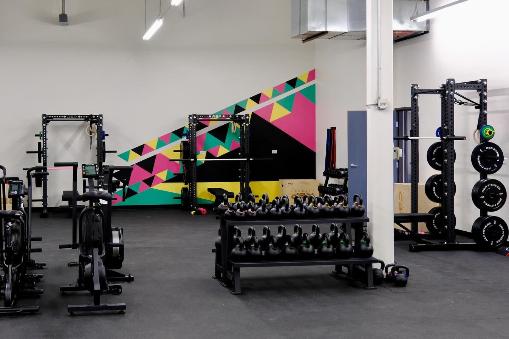 Person doing yoga on a mat, feet visible, with gray leggings, arms extended.