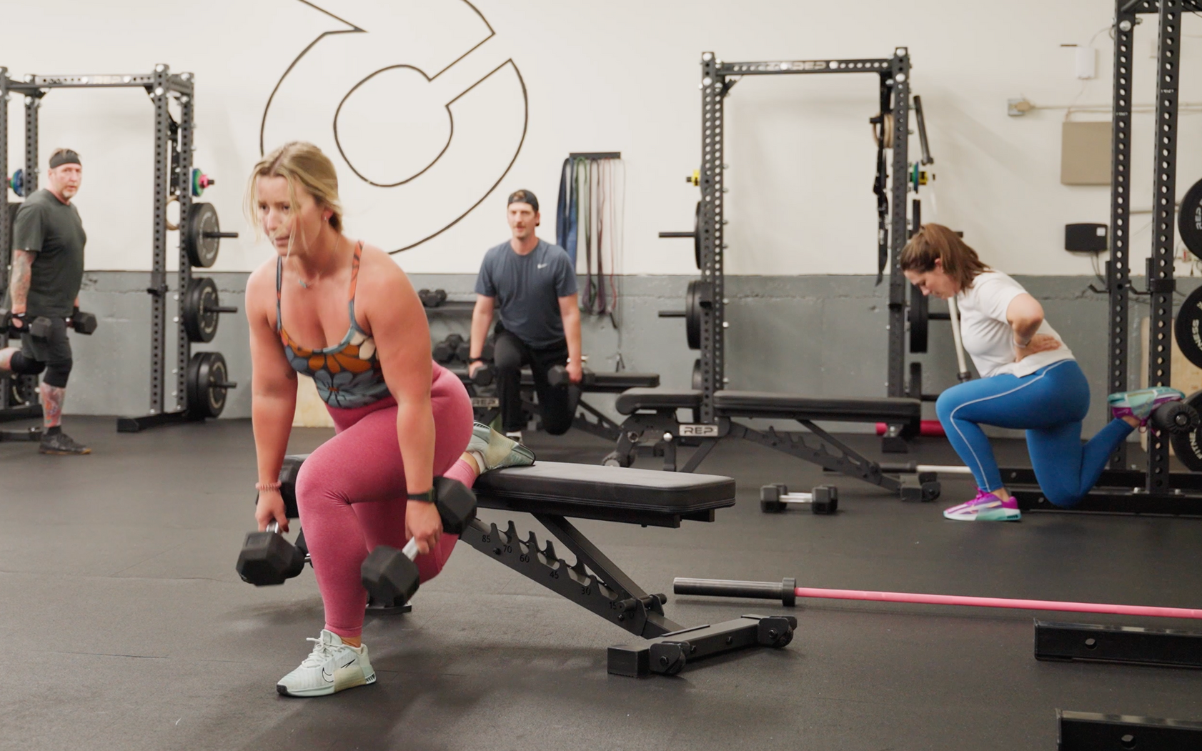 People doing yoga in a studio with raised arms.
