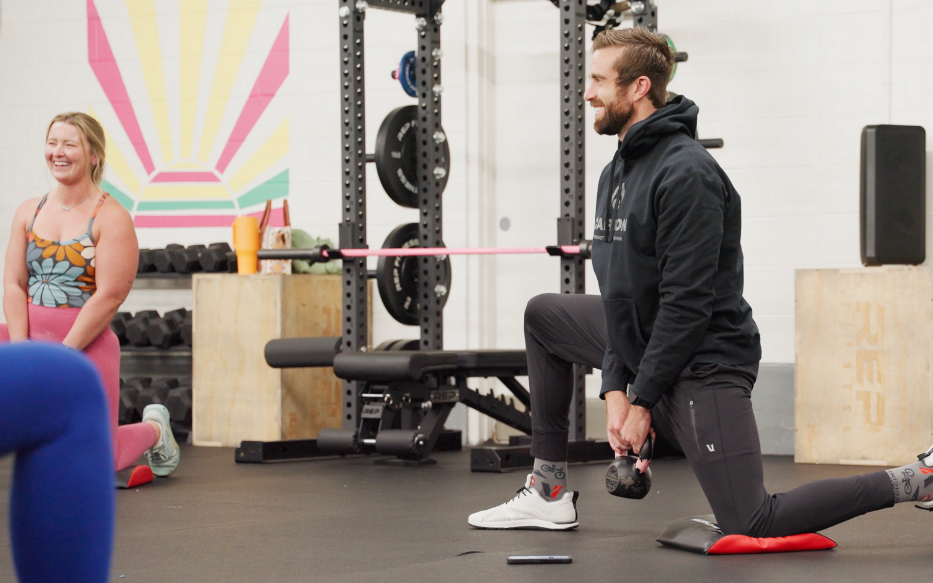 Person doing yoga on a mat, feet visible, with gray leggings, arms extended.