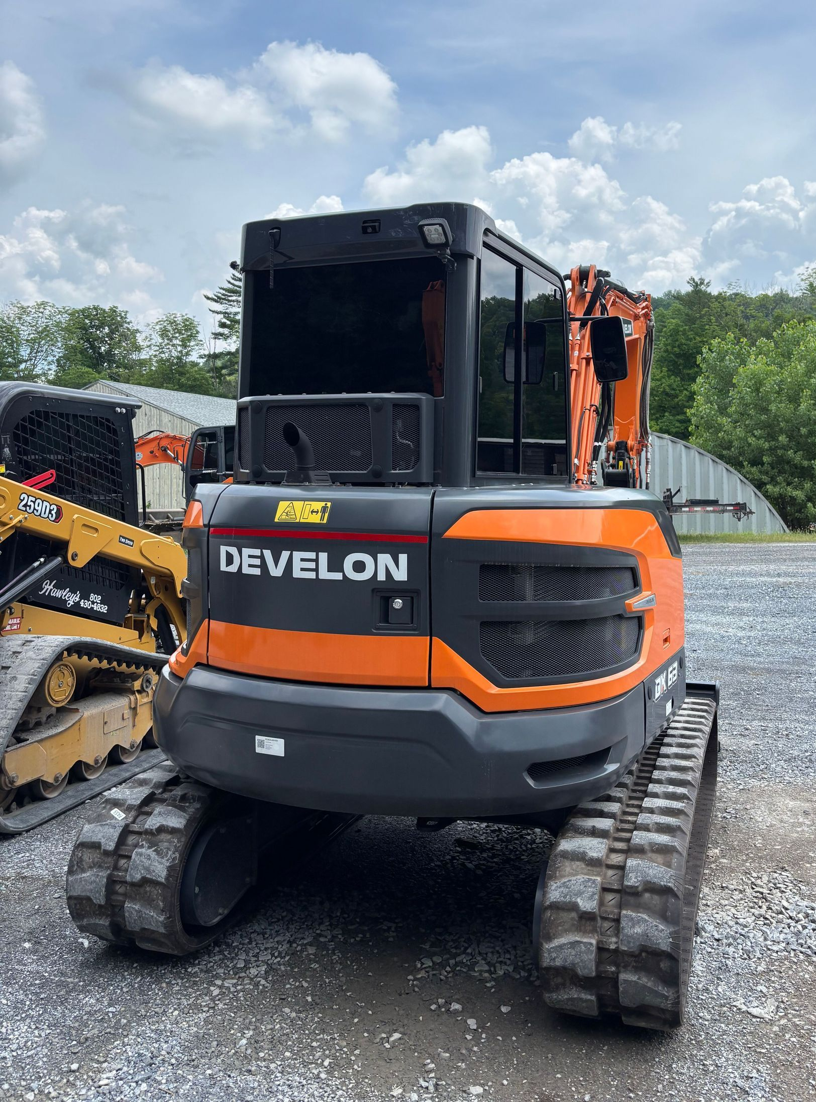 A person wearing black gloves is polishing the hood of a red car.