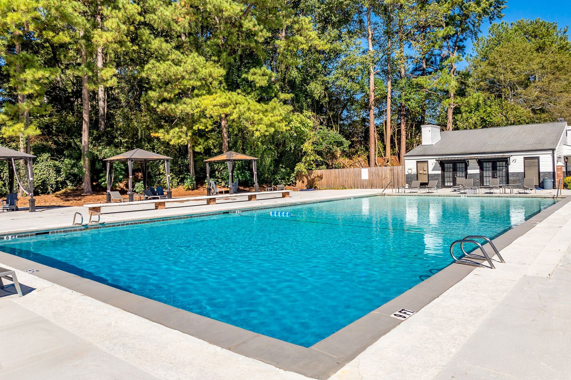 Ranch-style house with brick and gray accents, front porch, and lush landscaping.