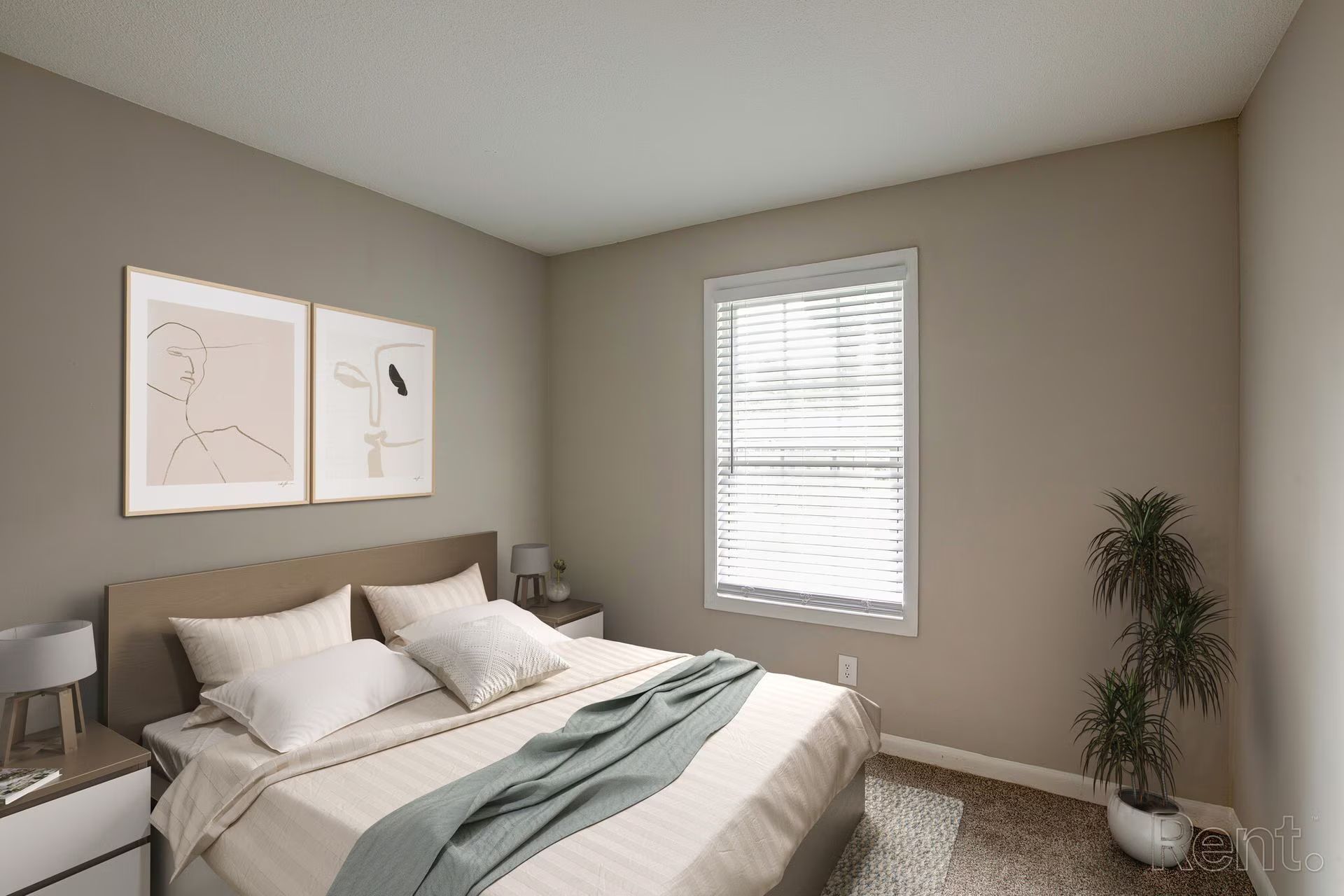 Dining area with glass table, chairs, artwork, and view into kitchen and living room.