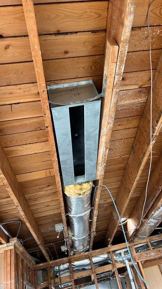 A metal pipe is hanging from the ceiling of a house.