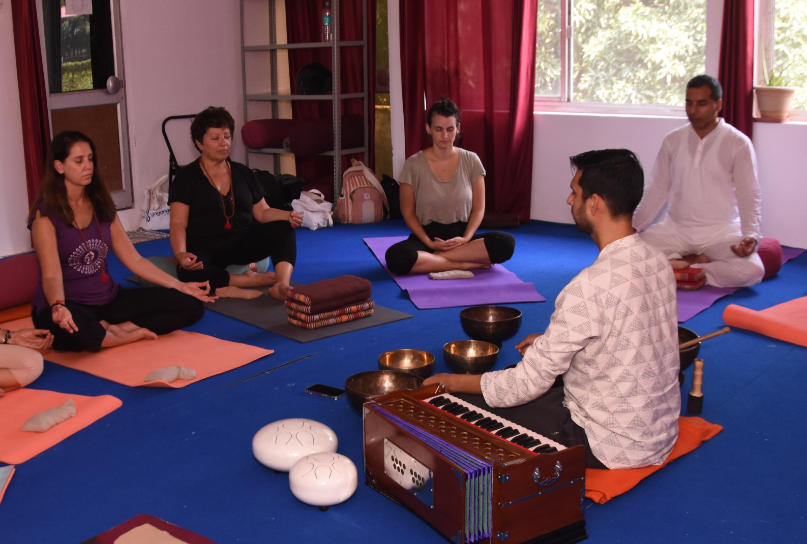 Group of people experiencing the power of Nada Yoga, the yoga of sound and Tibetan Singing Bowls
