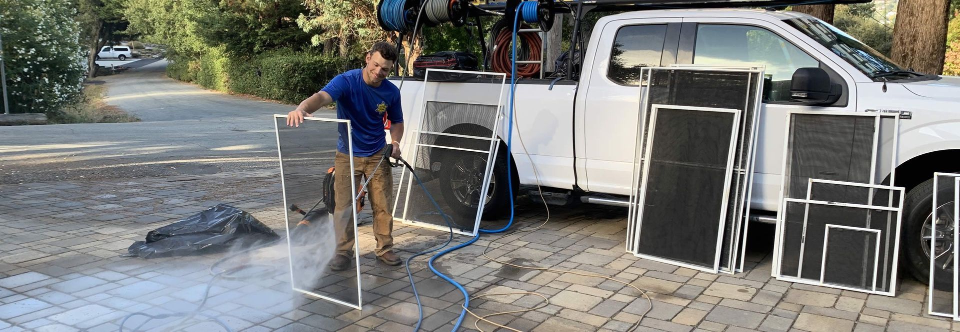 A man is cleaning a window with a squeegee.