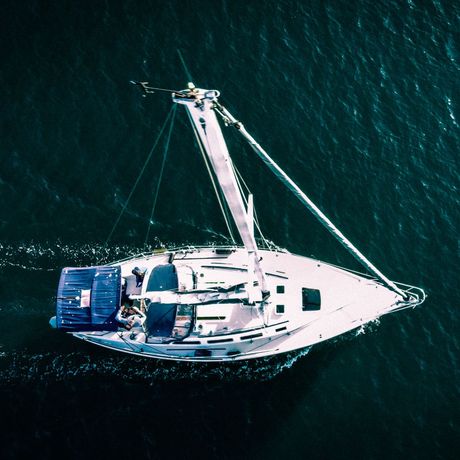 An aerial view of a sailboat in the ocean