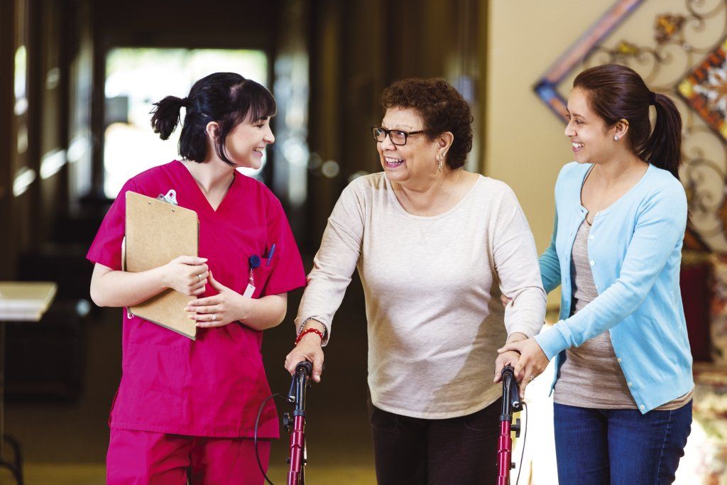 Woman in a walker with an aid and nurse at Northlake Gastroenterology Associates.