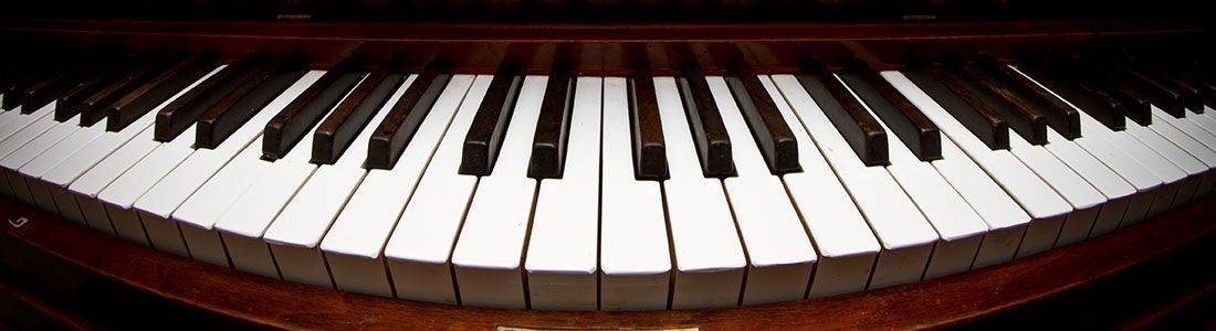 Close-up of piano keys on a polished wooden keyboard