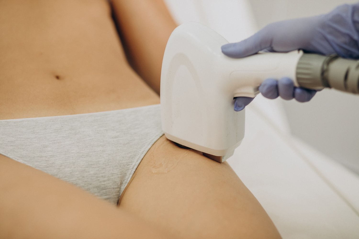 Person receiving laser hair removal treatment on the inner thigh.