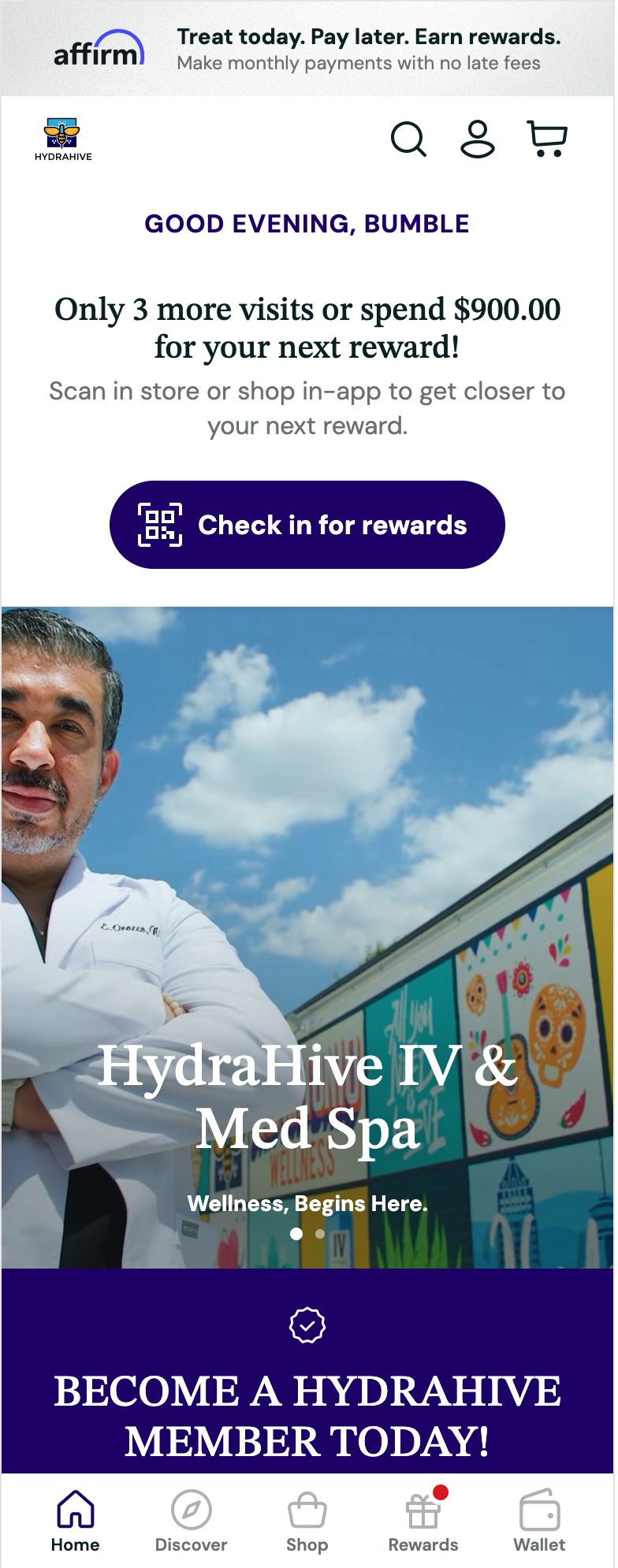 A woman is sitting on a couch looking at her cell phone.