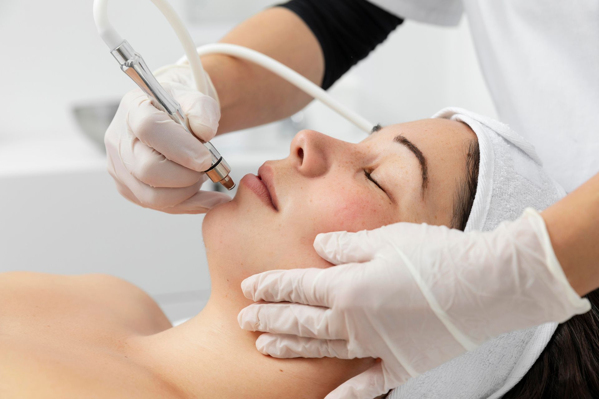 A woman is getting a facial treatment at a beauty salon.