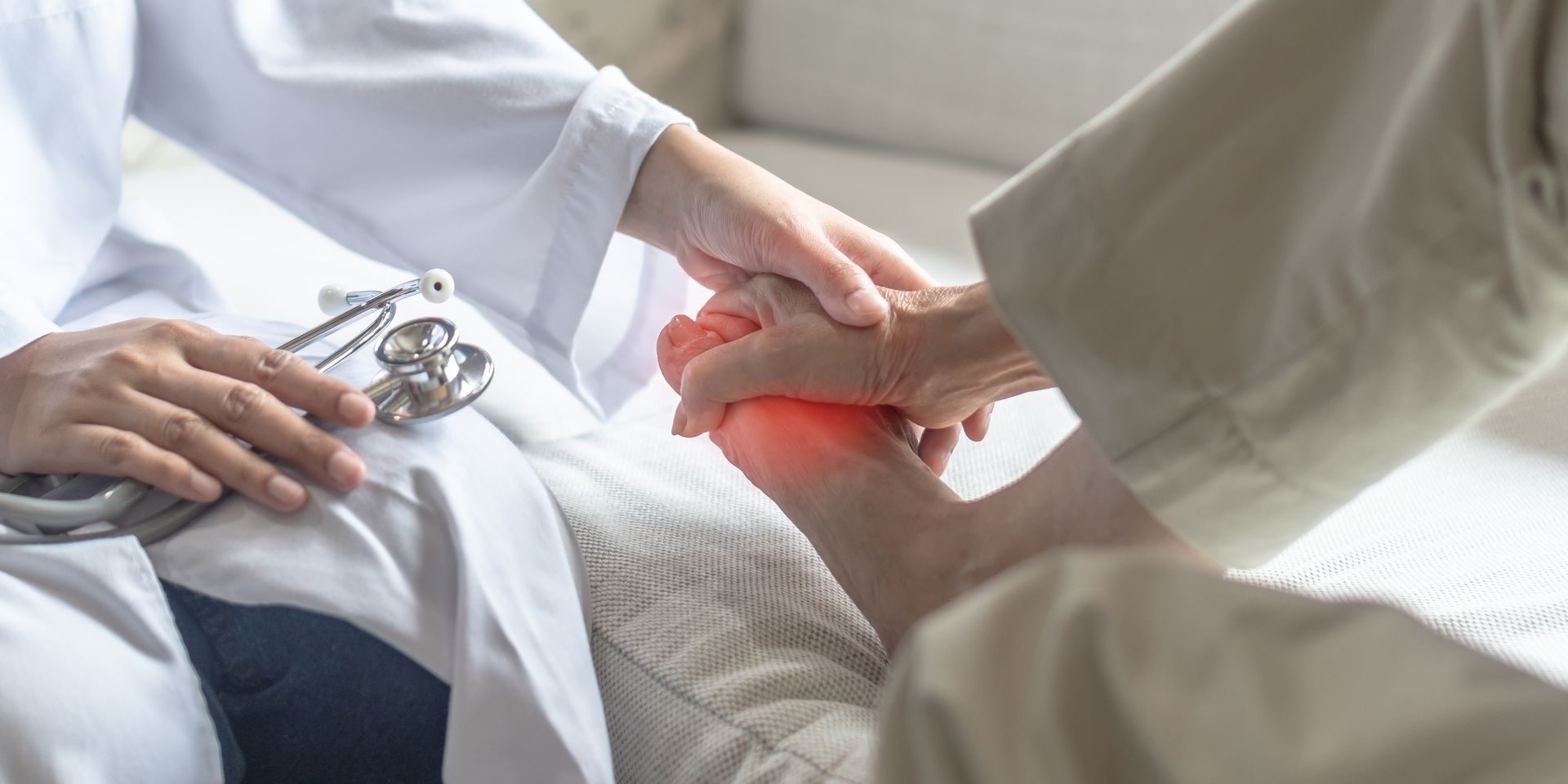 Doctor examining a patient's foot. A red glow indicates pain.