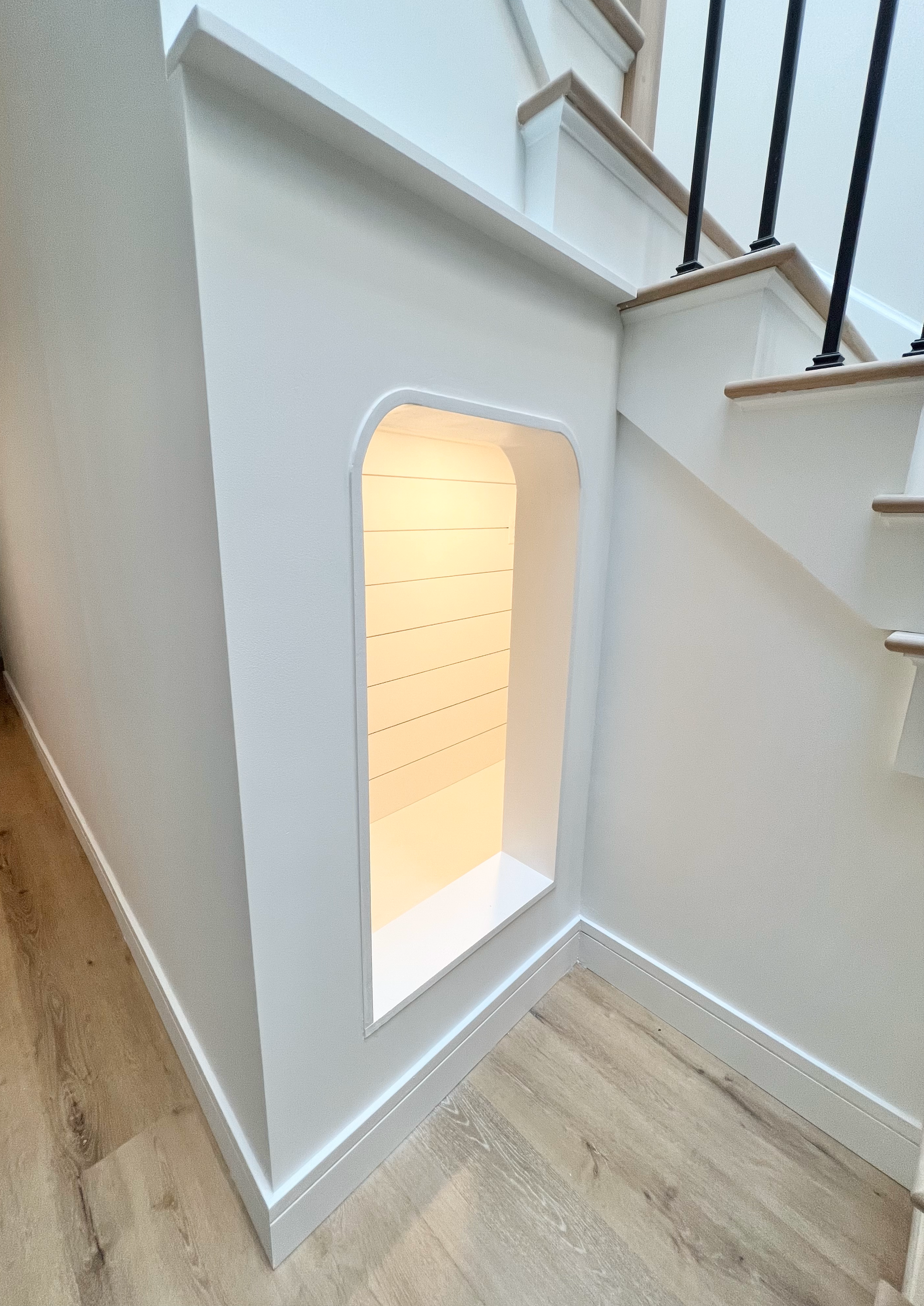 Custom-built children's play area under the staircase.