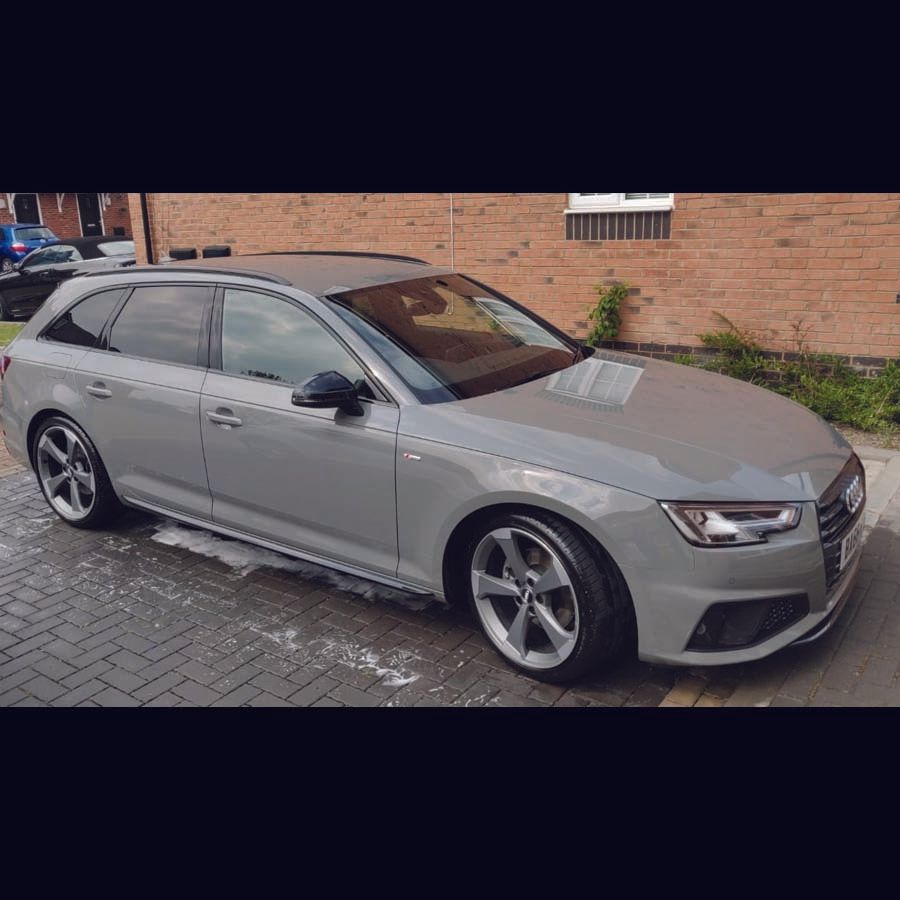 car parked outside house with soap suds underneath