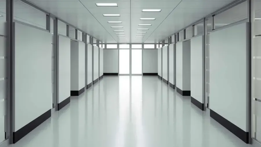 Empty, bright hallway leading to a bright window at the end.