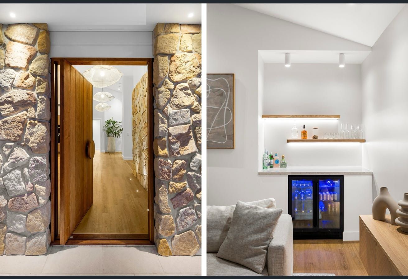 Stone entryway and small bar area. Wooden door opens to hall. Bar has shelves, cooler, and couch.