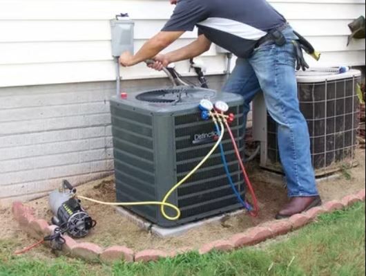 a man is working on an air conditioner outside of a house
