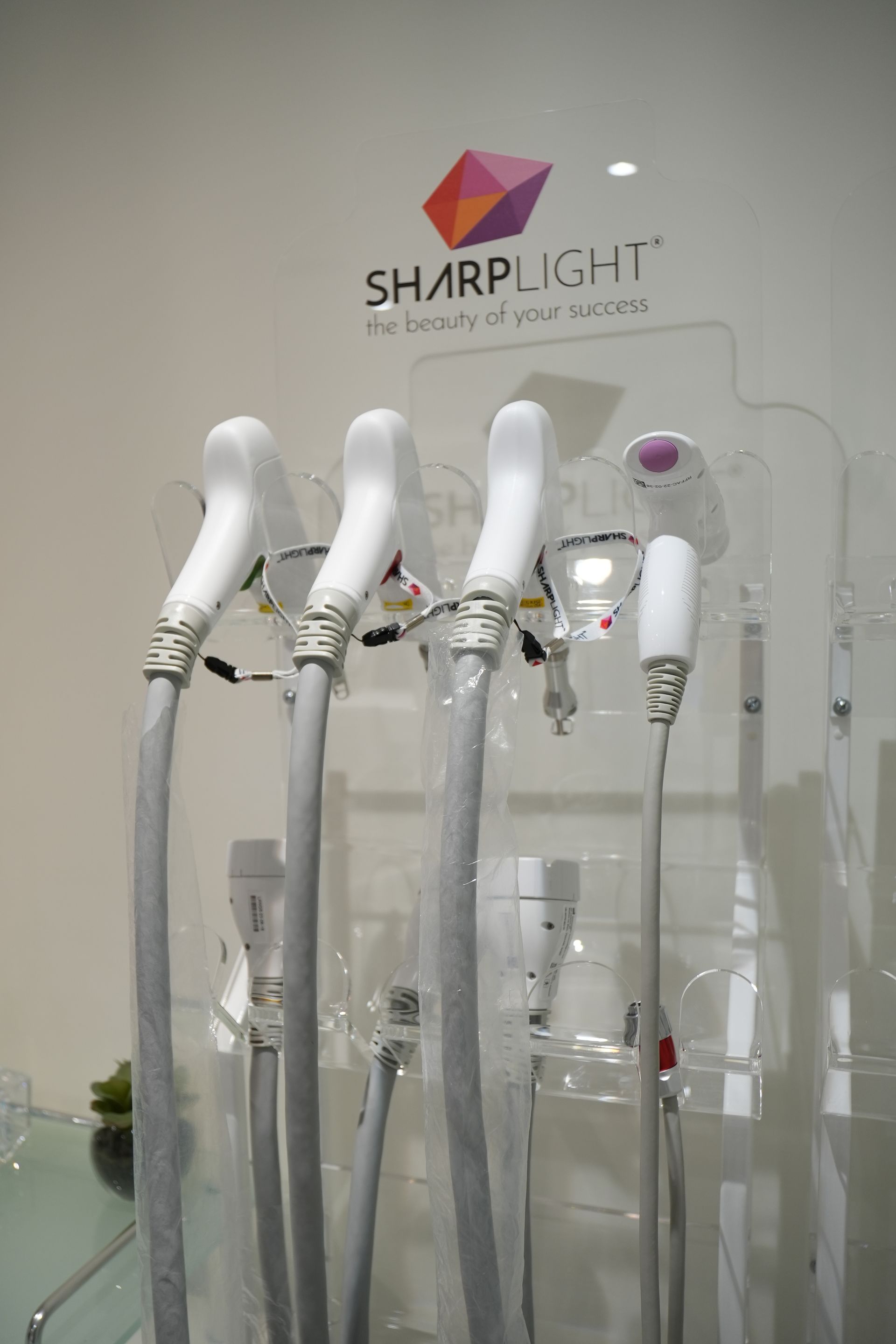 A sharplight machine is sitting on a glass table.