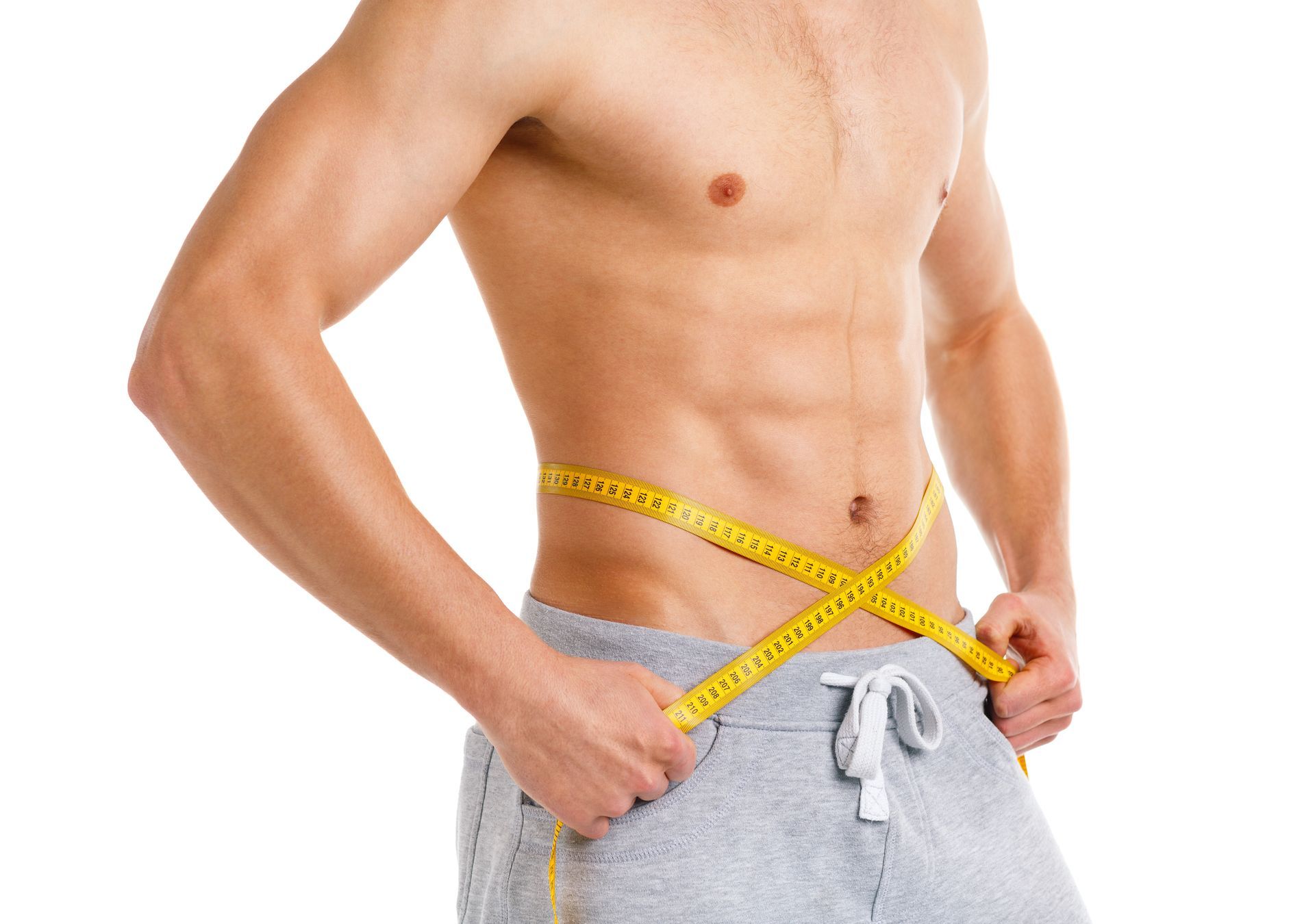 A shirtless man is measuring his waist with a tape measure