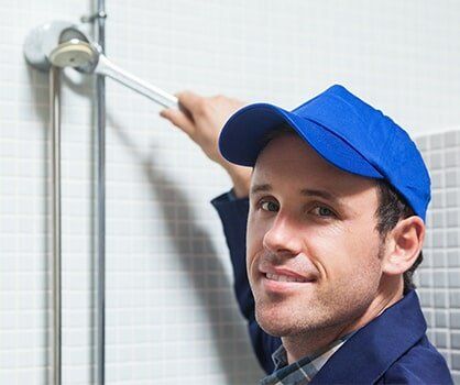 plumber repairing shower head - plumbing services in San Tan Valley