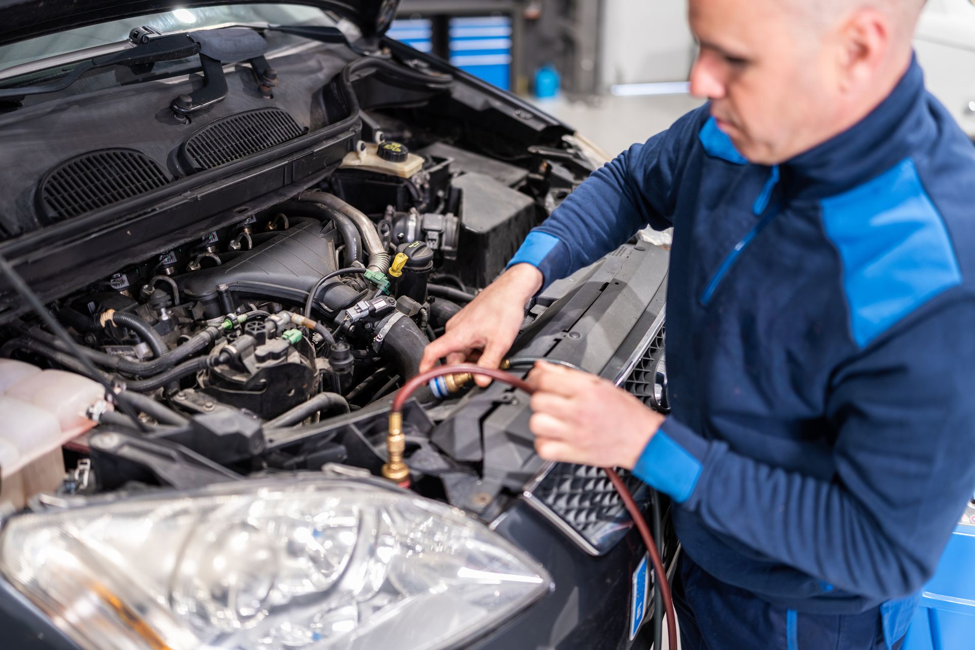 A mechanic examining engine oil in a vehicle, highlighting essential vehicle repair practices. A mechanic examining engine oil in a vehicle, highlighting essential vehicle repair practices.