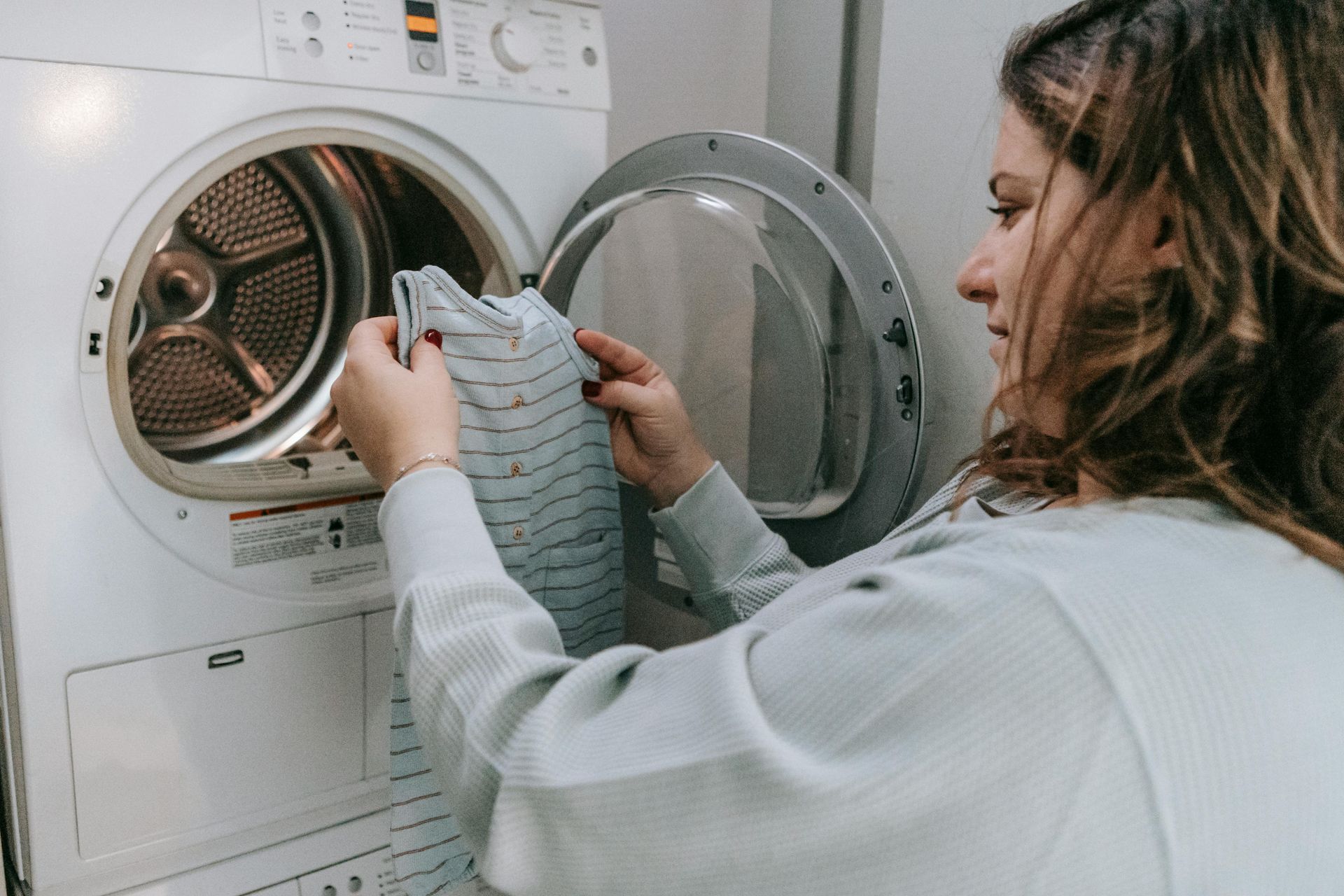 Woman loads Washing Machine