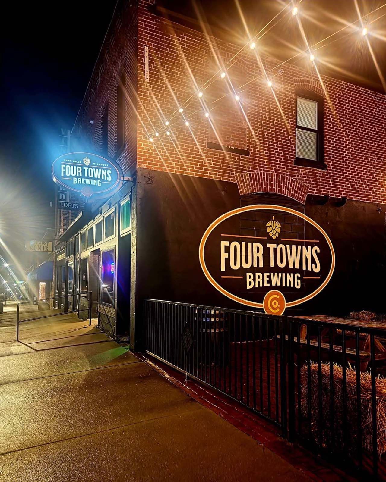 A brick building with a sign that says four towns brewing on it.