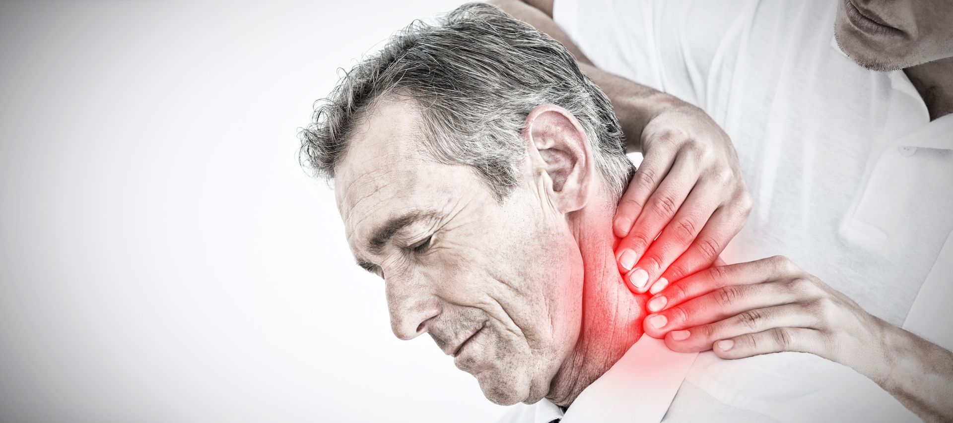 Therapist applying pressure to a man's neck to relieve pain and tension