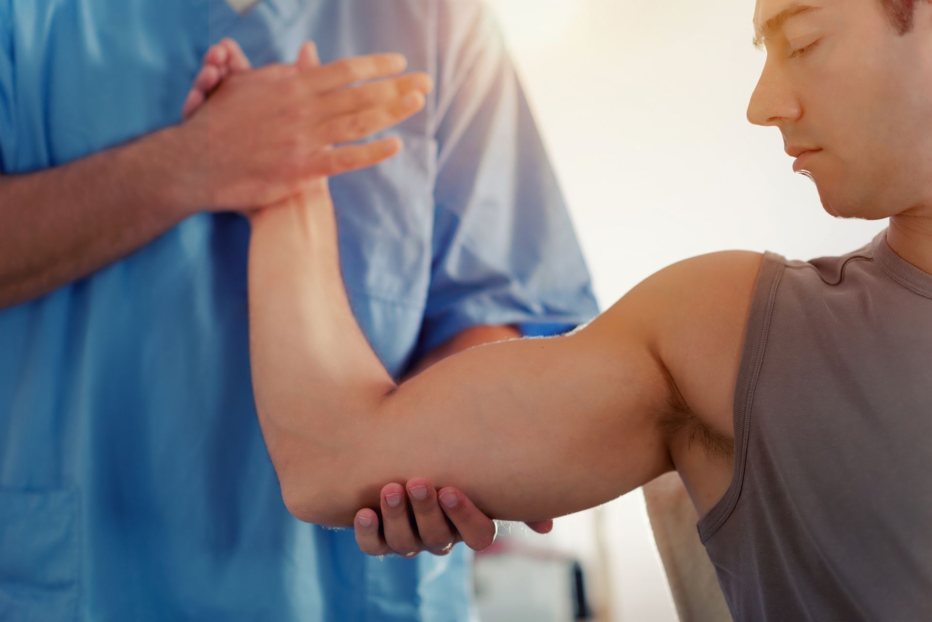 Man Doing Healing Treatment on Patient's Arm — Charlotte, NC — Greenapple Sports & Wellness