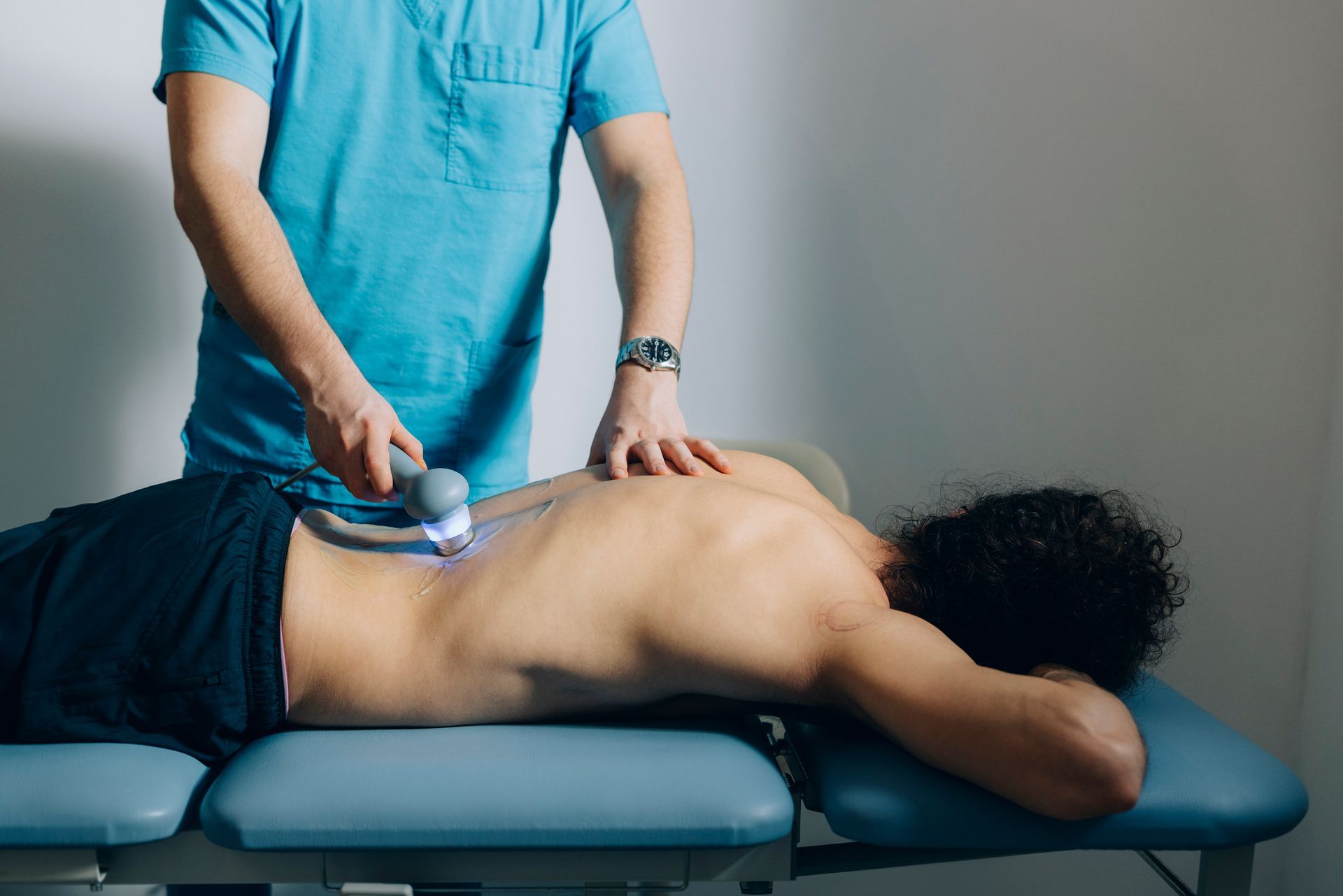 Man Using Laser Therapy — Charlotte, NC — Greenapple Sports & Wellness