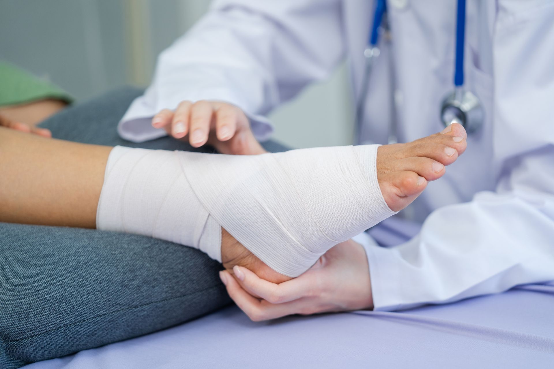 Specialist Helping Troubled Patient with Foot Injury — Charlotte, NC — Greenapple Sports & Wellness