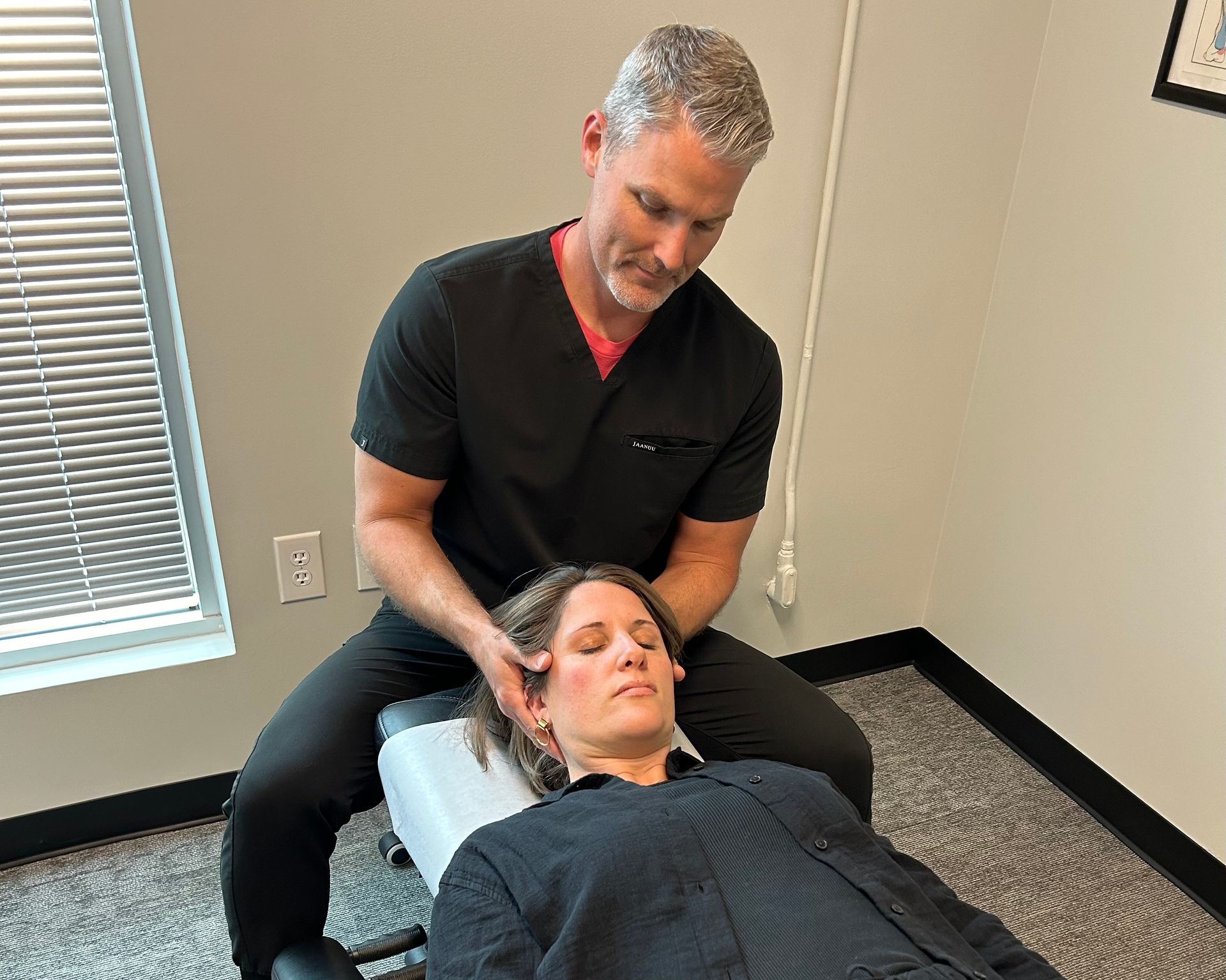 Man Doing Neck Adjustment on a Male Patient — Charlotte, NC — Greenapple Sports & Wellness