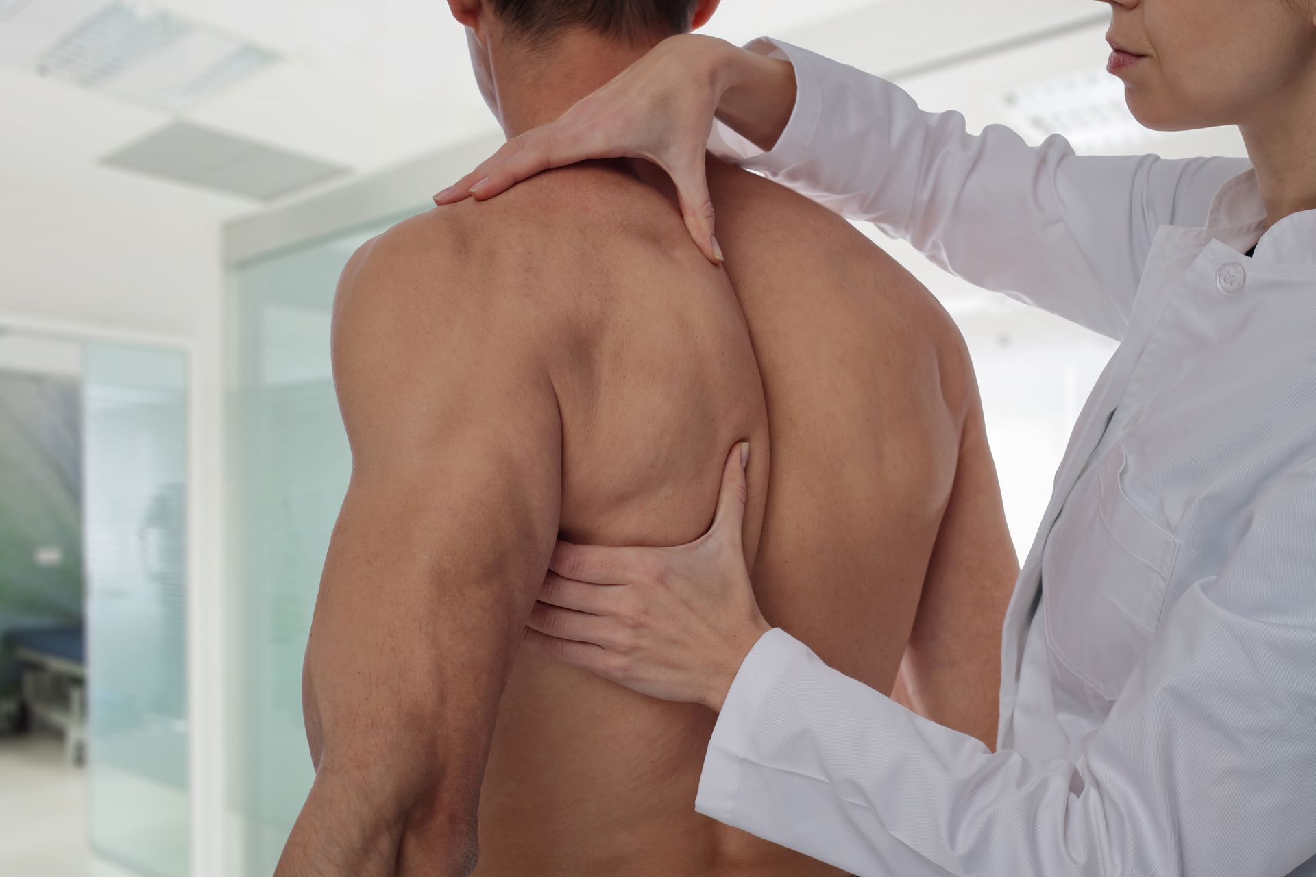 Therapist Doing Healing Treatment on Man's Back — Charlotte, NC — Greenapple Sports & Wellness