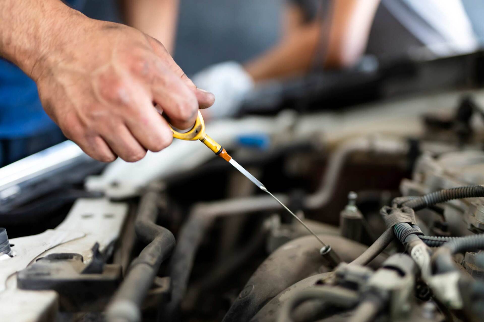 Mechanic inserting oil into car — Gary, IN — Macer Transportation