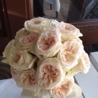 Bouquet of pale peach and white roses on a table