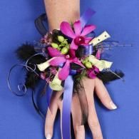 Hands with pink flower corsage, black feathers, and ribbon on a blue background