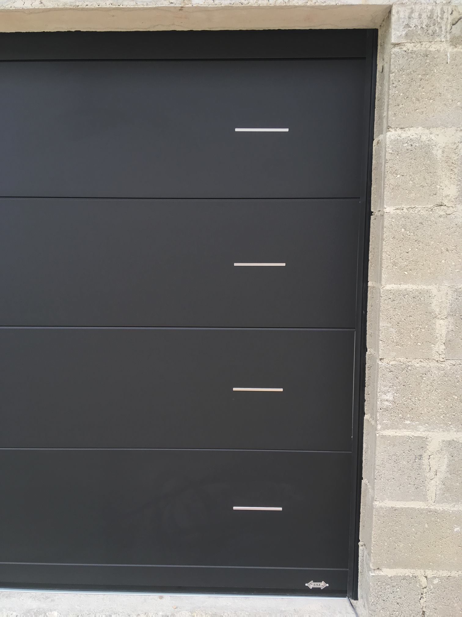 Porte de garage réalisation Trihome