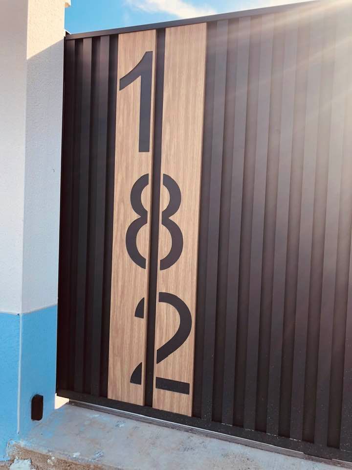 modèle de portail en aluminium au design contemporain de la gamme Structura, avec numéro sur créneau aspect bois chêne clair , du plus bel effet
