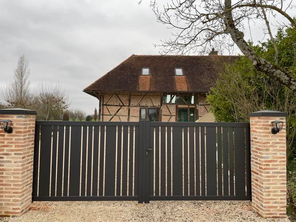 Portail en teinte noire 2100 sablée installé par TRIHOME Menuiseries à Villegaudin