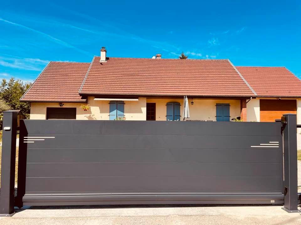 Portail sur mesure avec motifs réalisés en découpe jet d’eau installé à Pierre de Bresse par TRIHOME Menuiseries, en Bresse bourguignonne