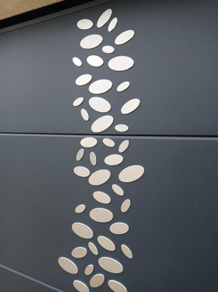 Porte de garage motorisée via double moteurs BFT Phebe installée par TRIHOME Menuiseries à La Chapelle-Naude.