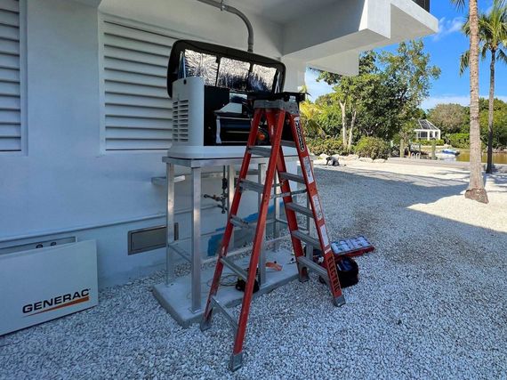 A ladder is sitting on top of a table in front of a building.