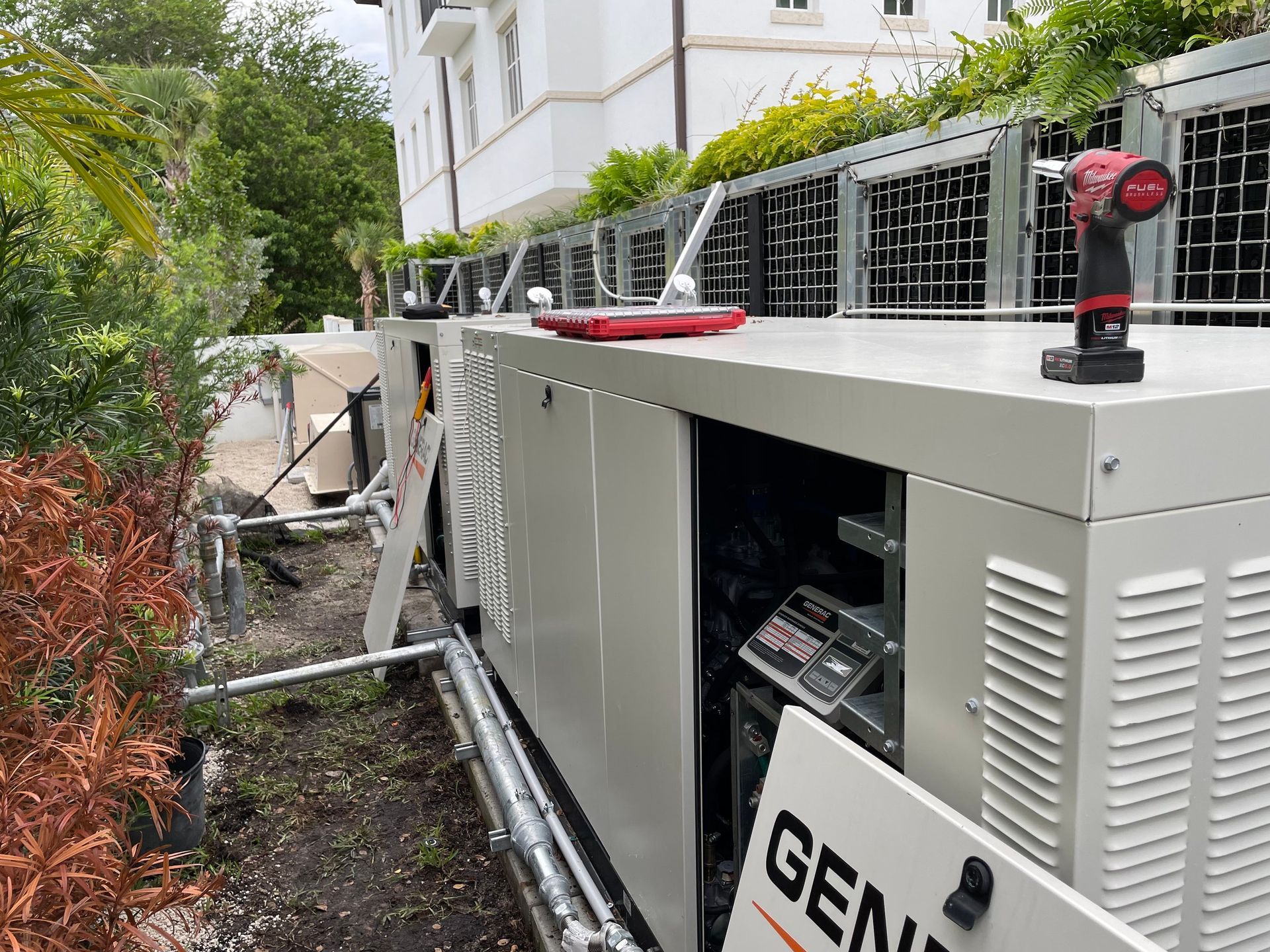 A drill is sitting on top of a generator.