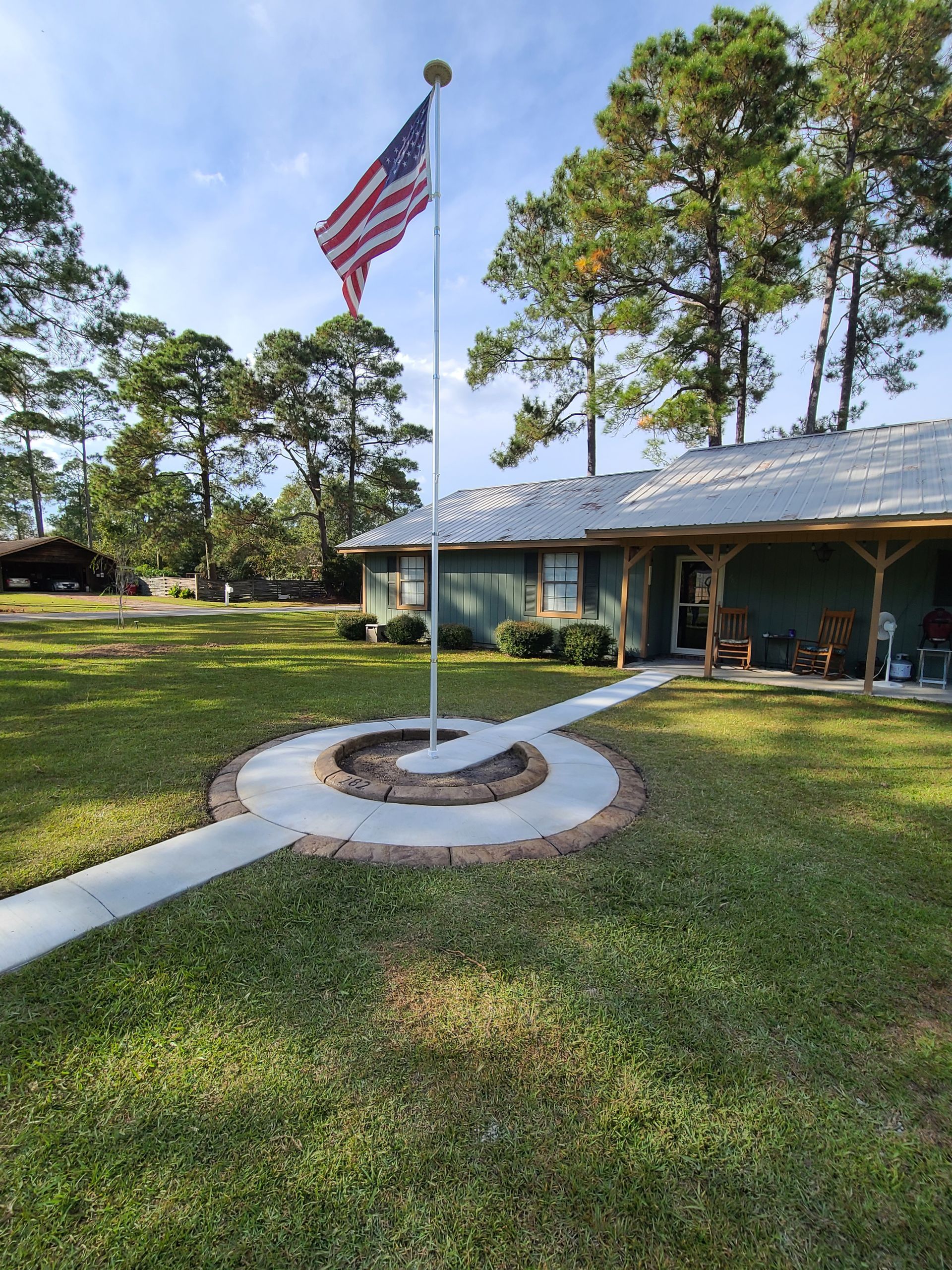 An american flag is flying in front of a house