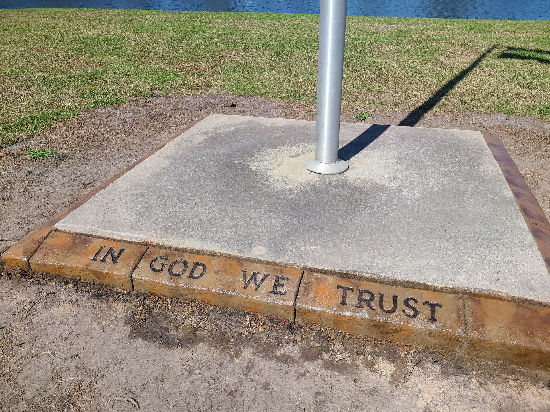 A concrete base with the words in god we trust written on it
