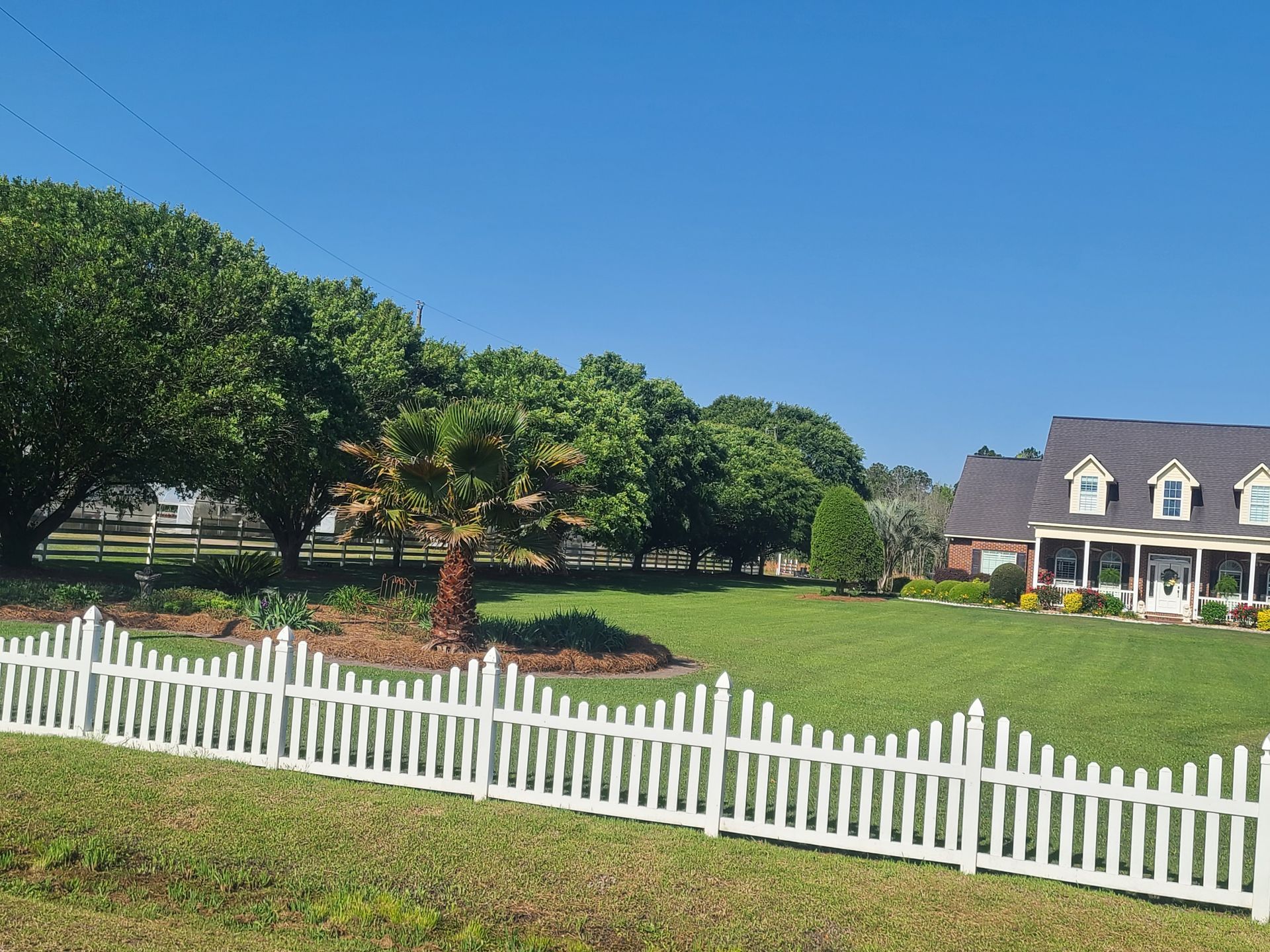 A white picket fence in front of a house